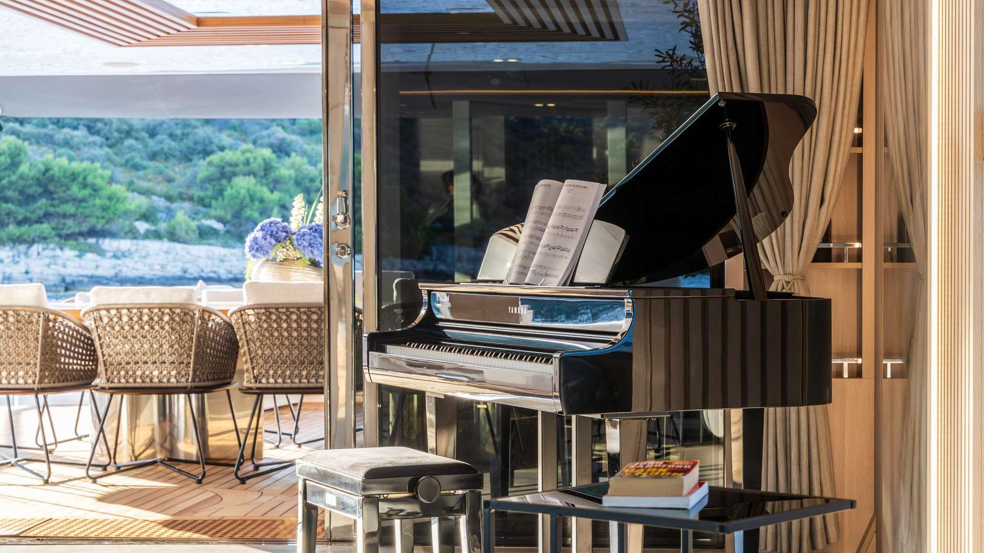 luxury yacht grand piano with open lid and sheet music in modern salon