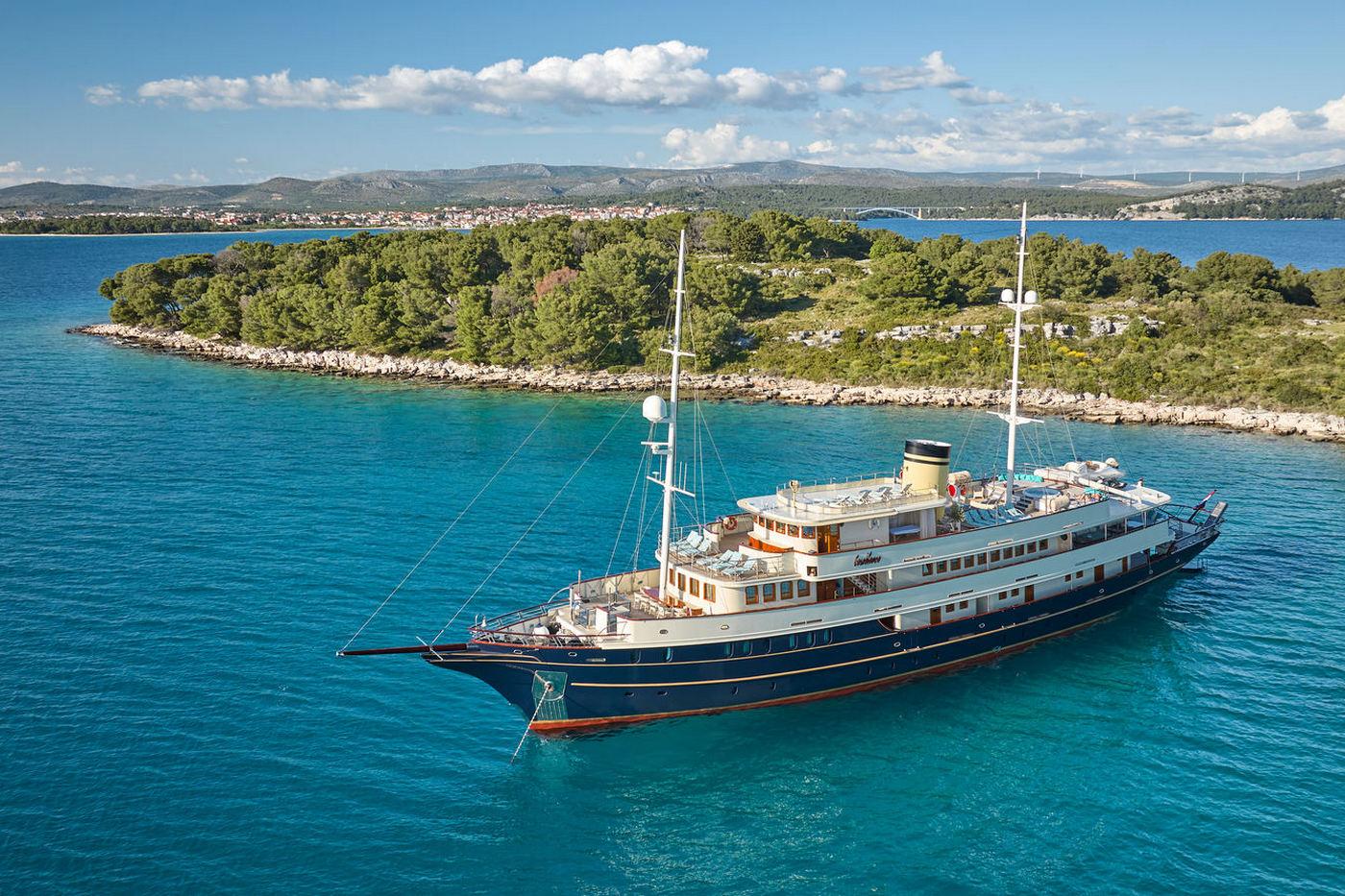 aerial view luxury yacht anchored in crystal clear turquoise bay
