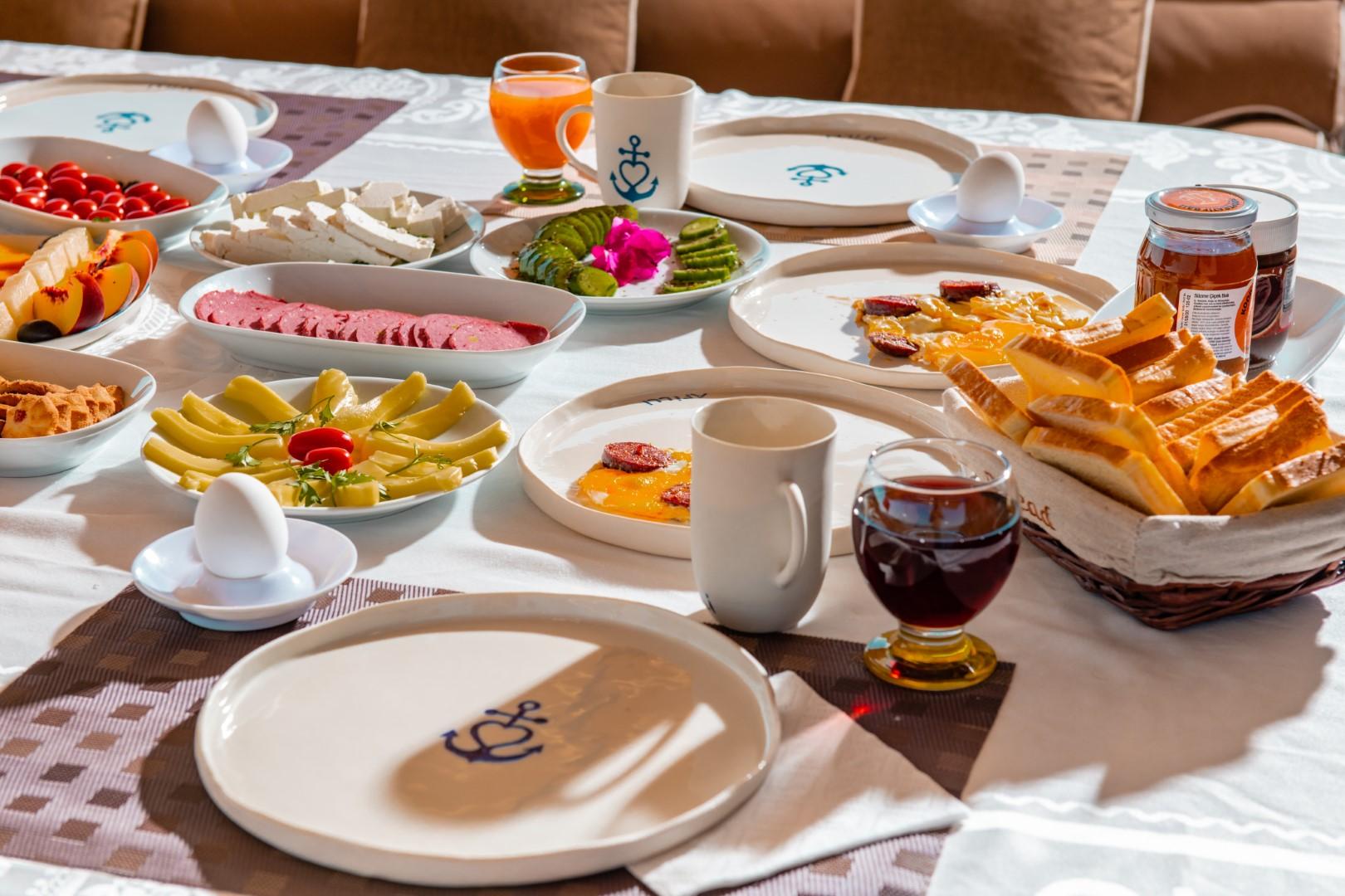 luxury yacht breakfast table with Turkish börek pastries cheese platter and tea service