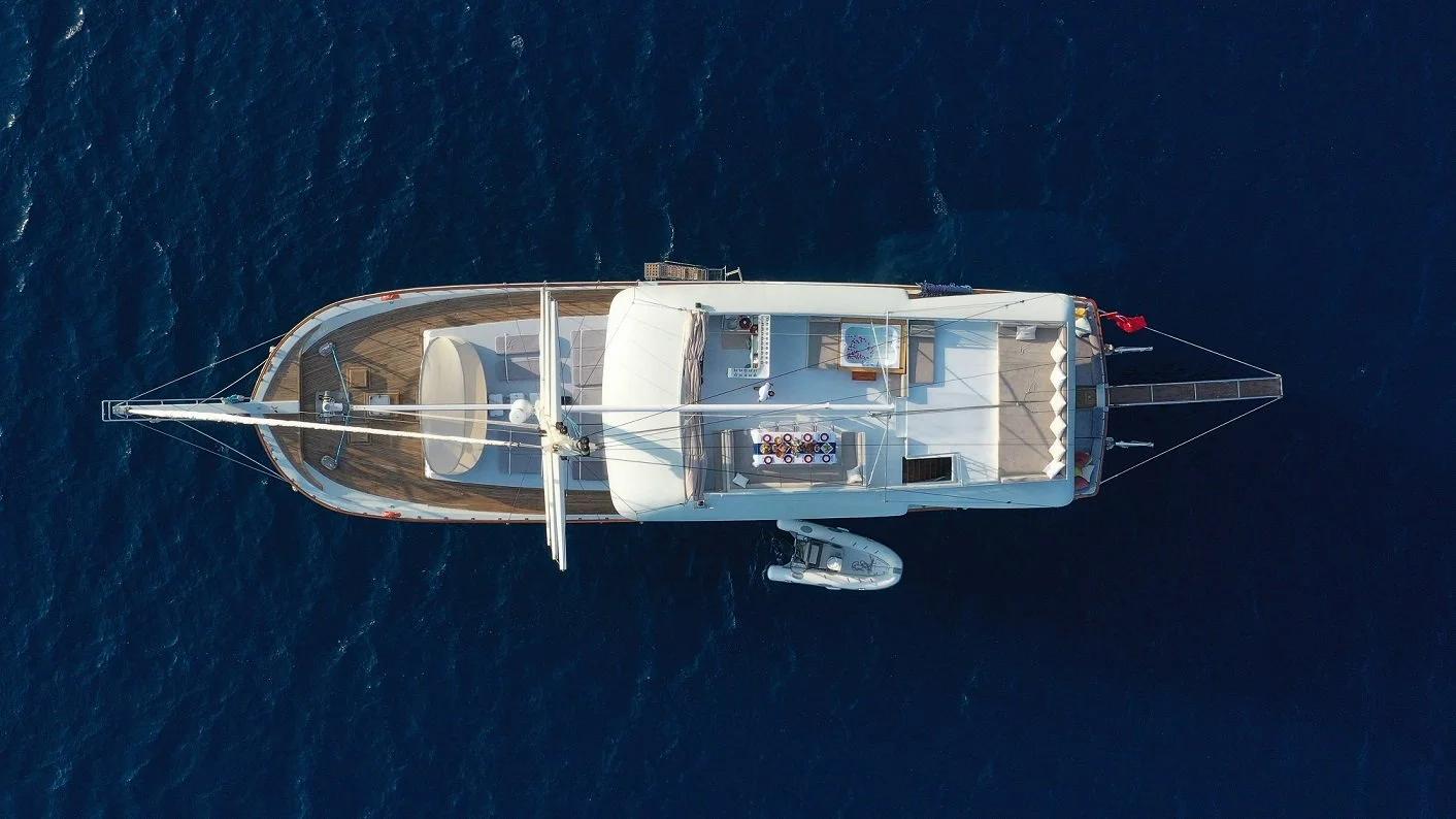 aerial view of luxury yacht deck layout with tender dinghy and seating areas