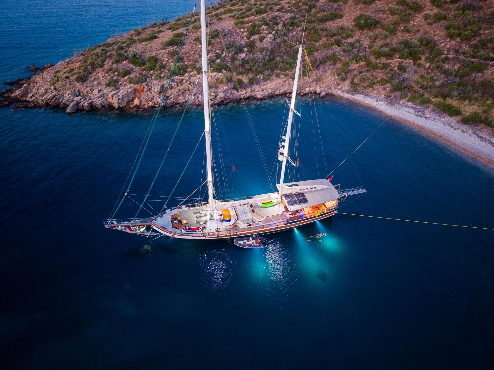 aerial view of traditional wooden gulet yacht anchored in turquoise Mediterranean bay