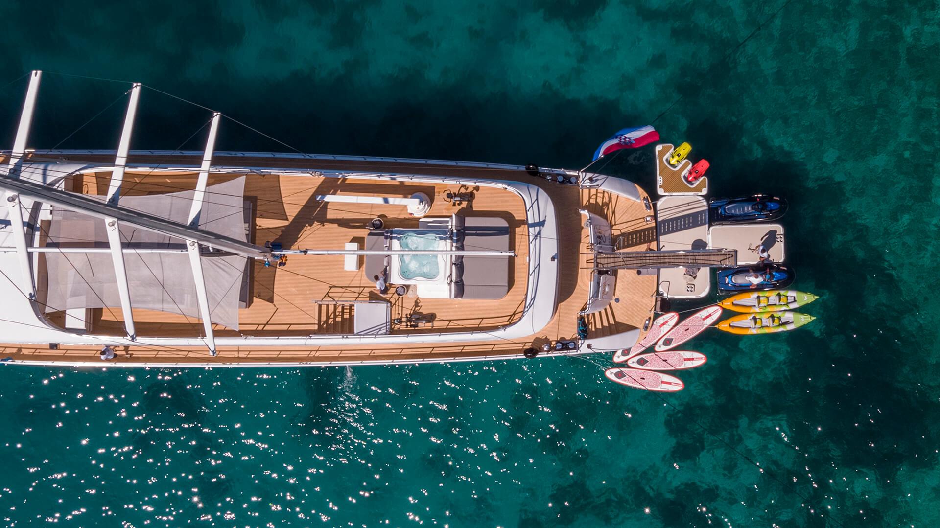 aerial view luxury yacht with jacuzzi and extensive water toys collection including kayaks paddleboards