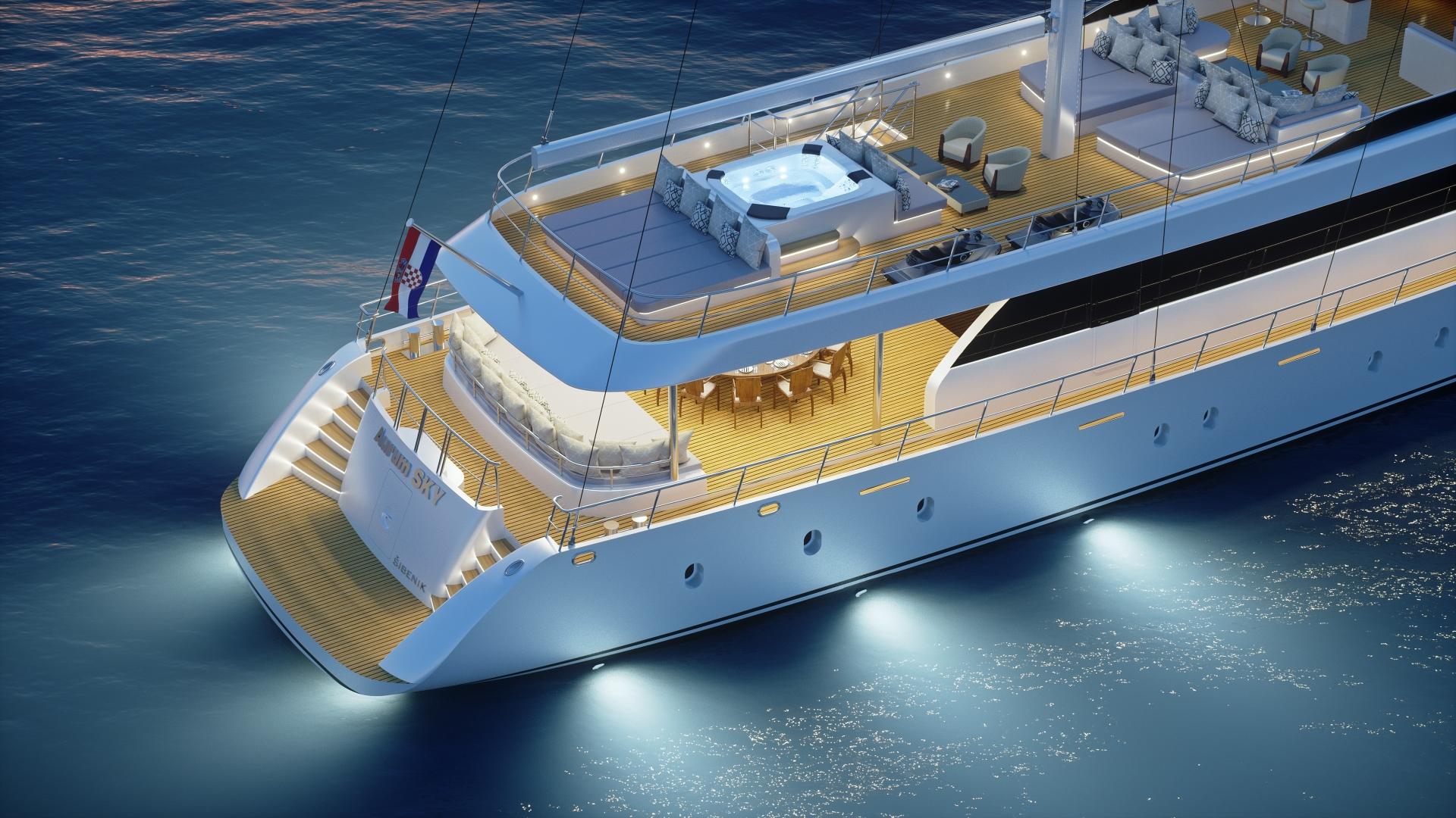 aerial view of white luxury yacht with teak decking and jacuzzi underway at night