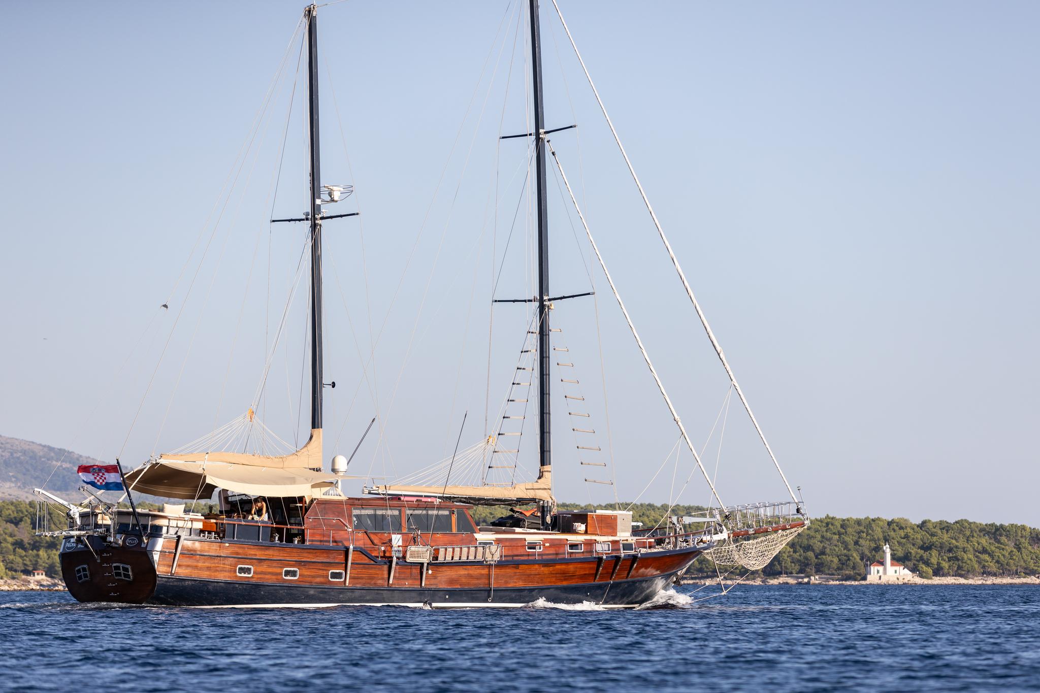 Traditional wooden gulet with two masts sailing on blue Mediterranean waters