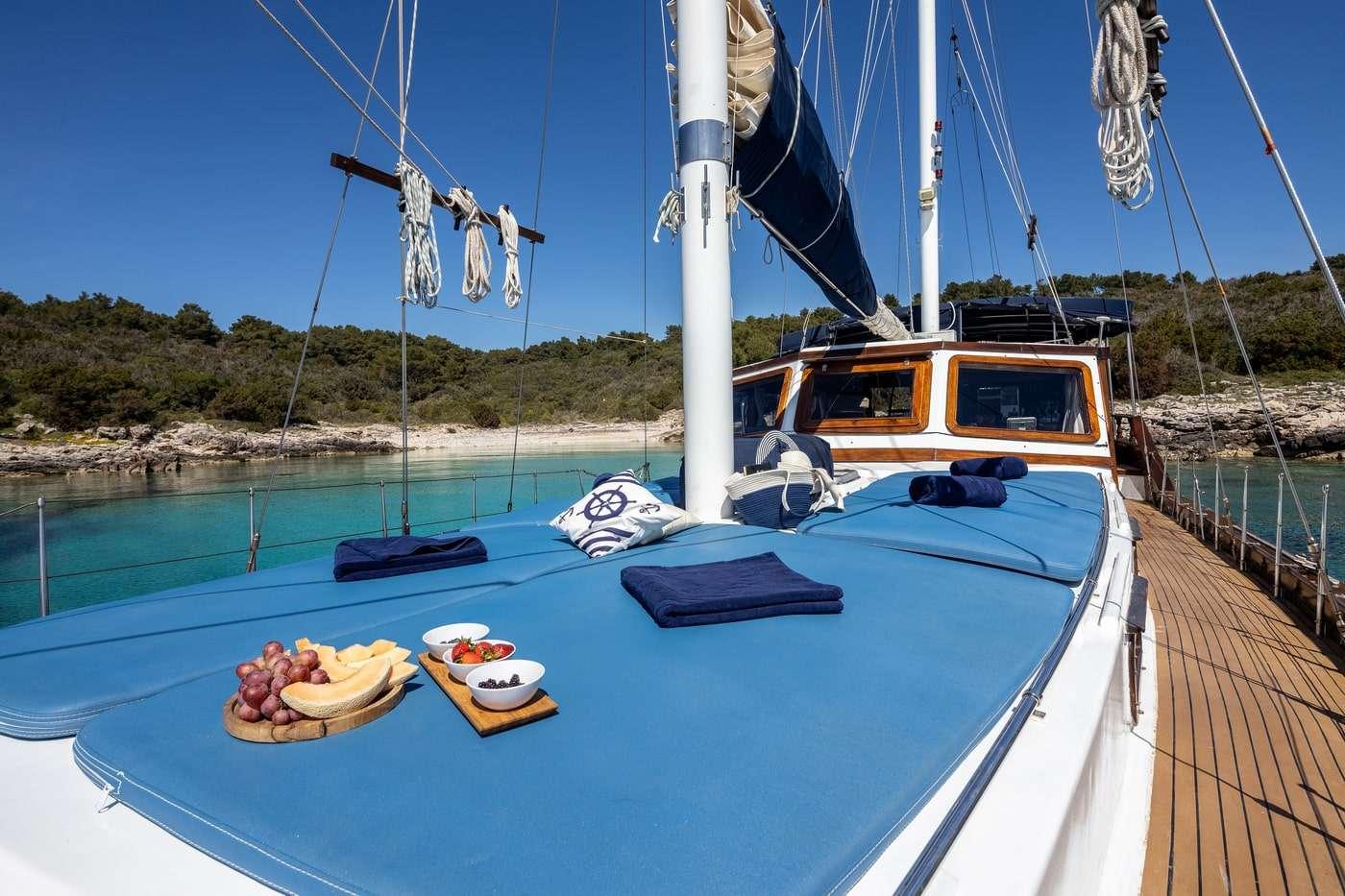 fresh fruit platter and olives served on blue deck with nautical cushions