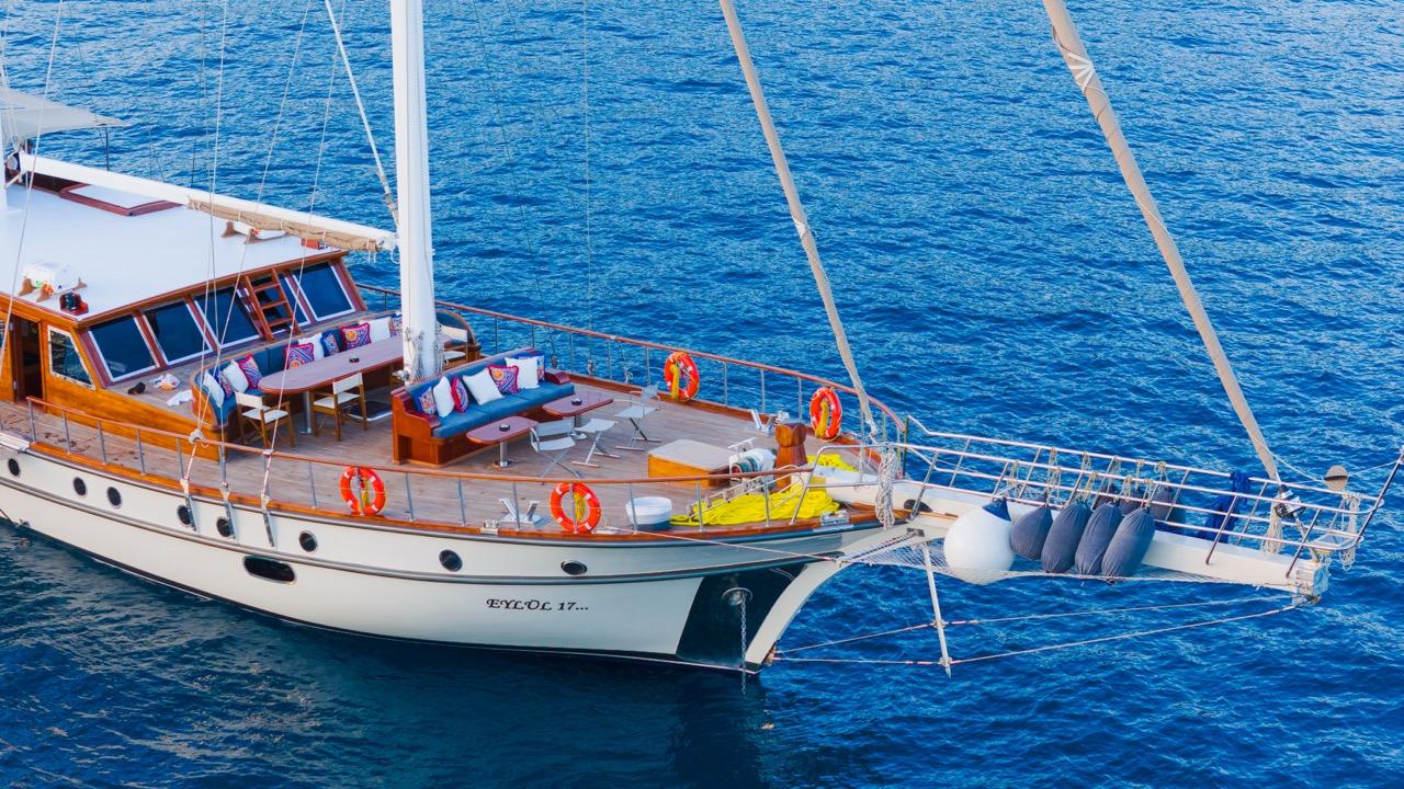 Traditional wooden gulet EYLUL 17 at anchor showing aft deck seating area and hull profile