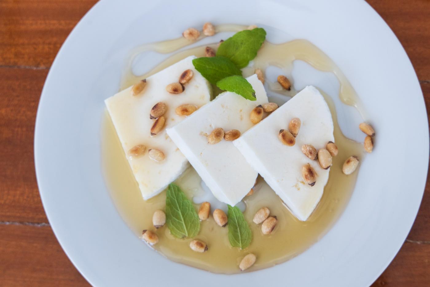 Turkish muhallebi dessert with crushed pistachios and mint garnish served on yacht