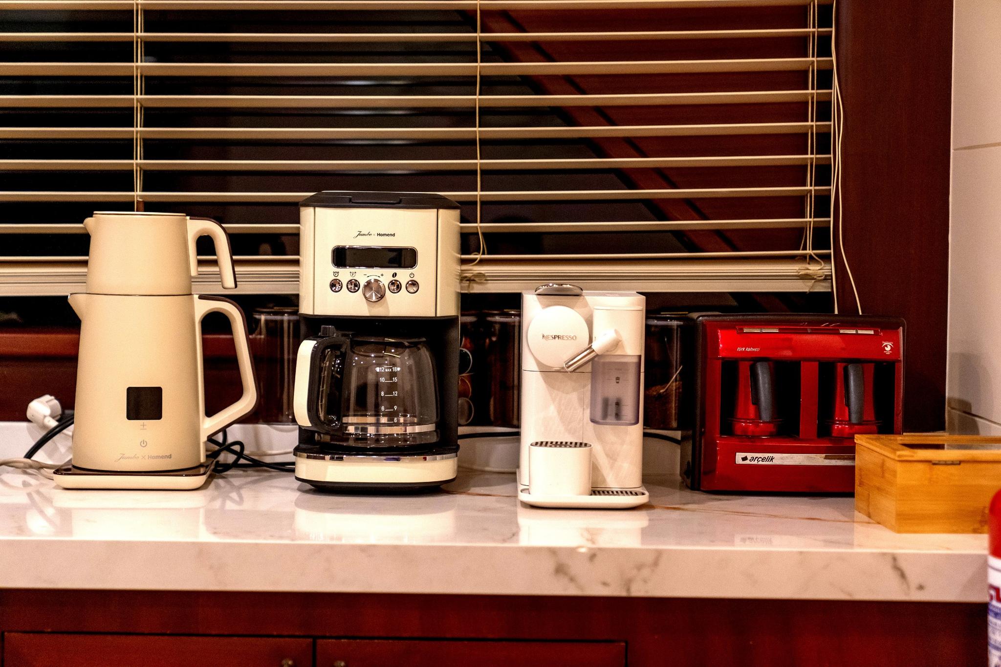 yacht galley coffee station with espresso machine, coffee maker, milk frother and popcorn maker