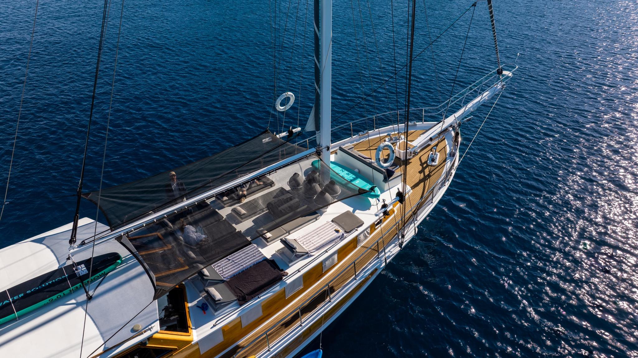 aerial view of luxury gulet deck showing outdoor lounge seating and teak decking