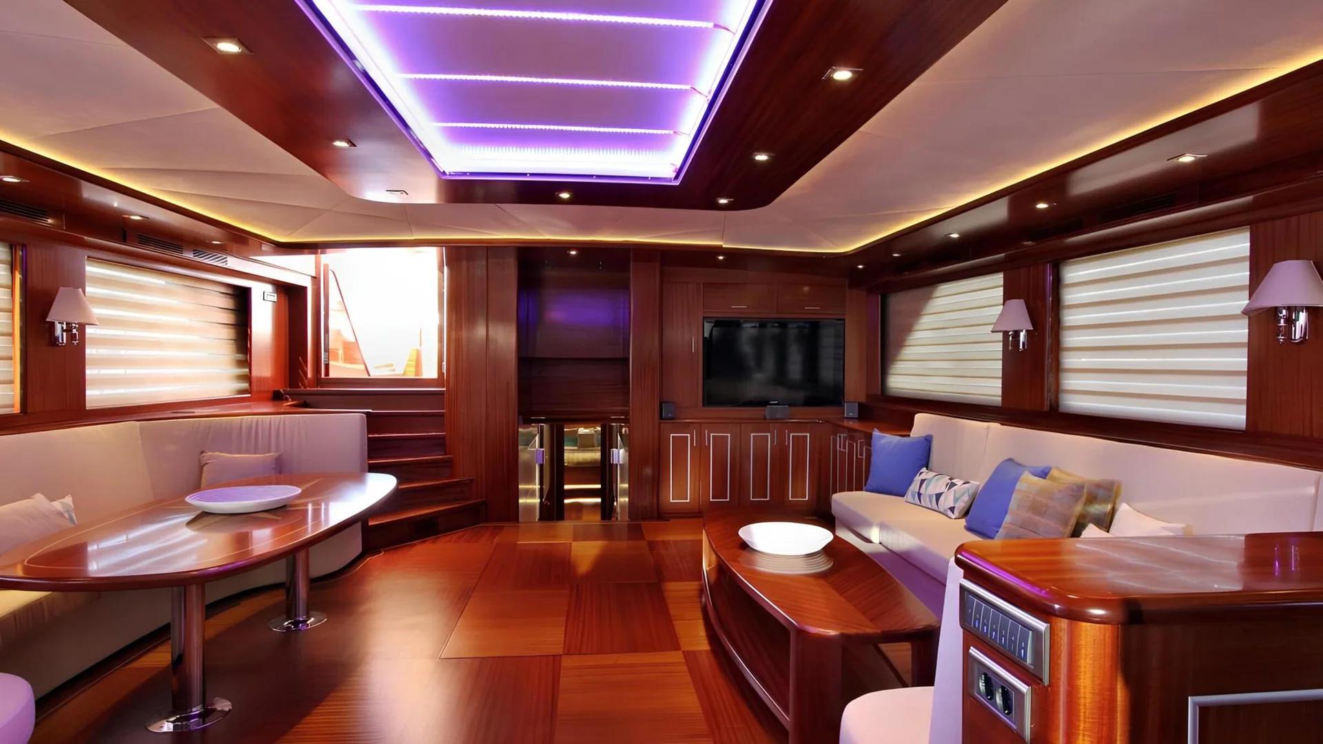 luxury yacht cinema room with wall-mounted TV screen, built-in seating and mahogany interior