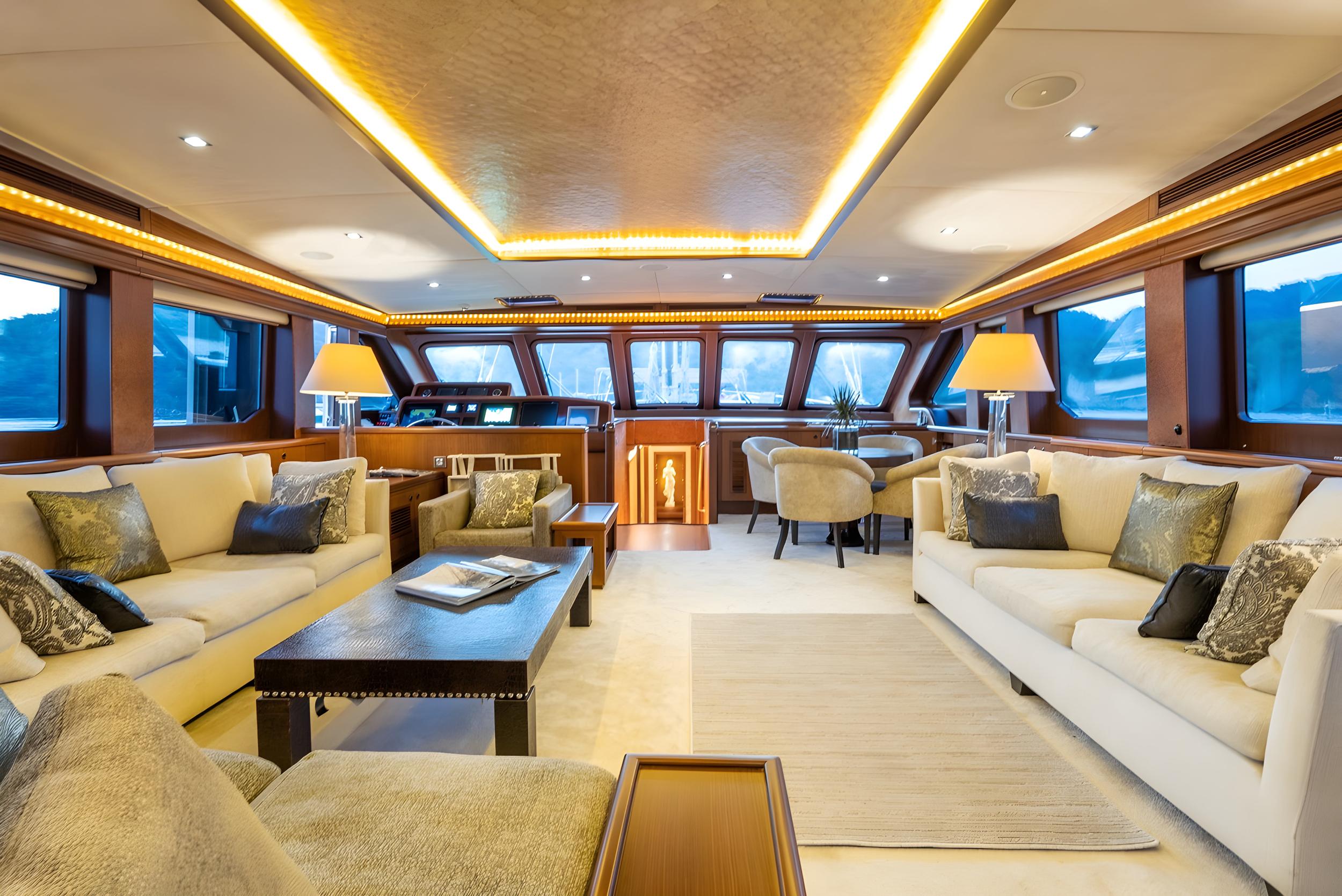luxury yacht main salon with cream sofas, coffee table, and panoramic windows