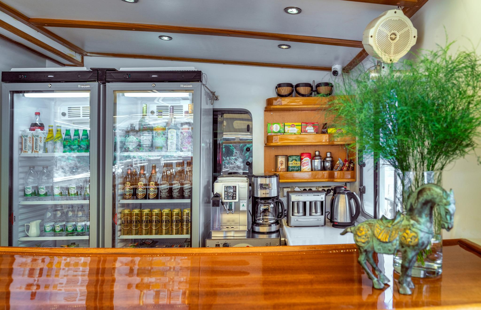 yacht galley bar with glass-door refrigerators stocked with drinks and beverages