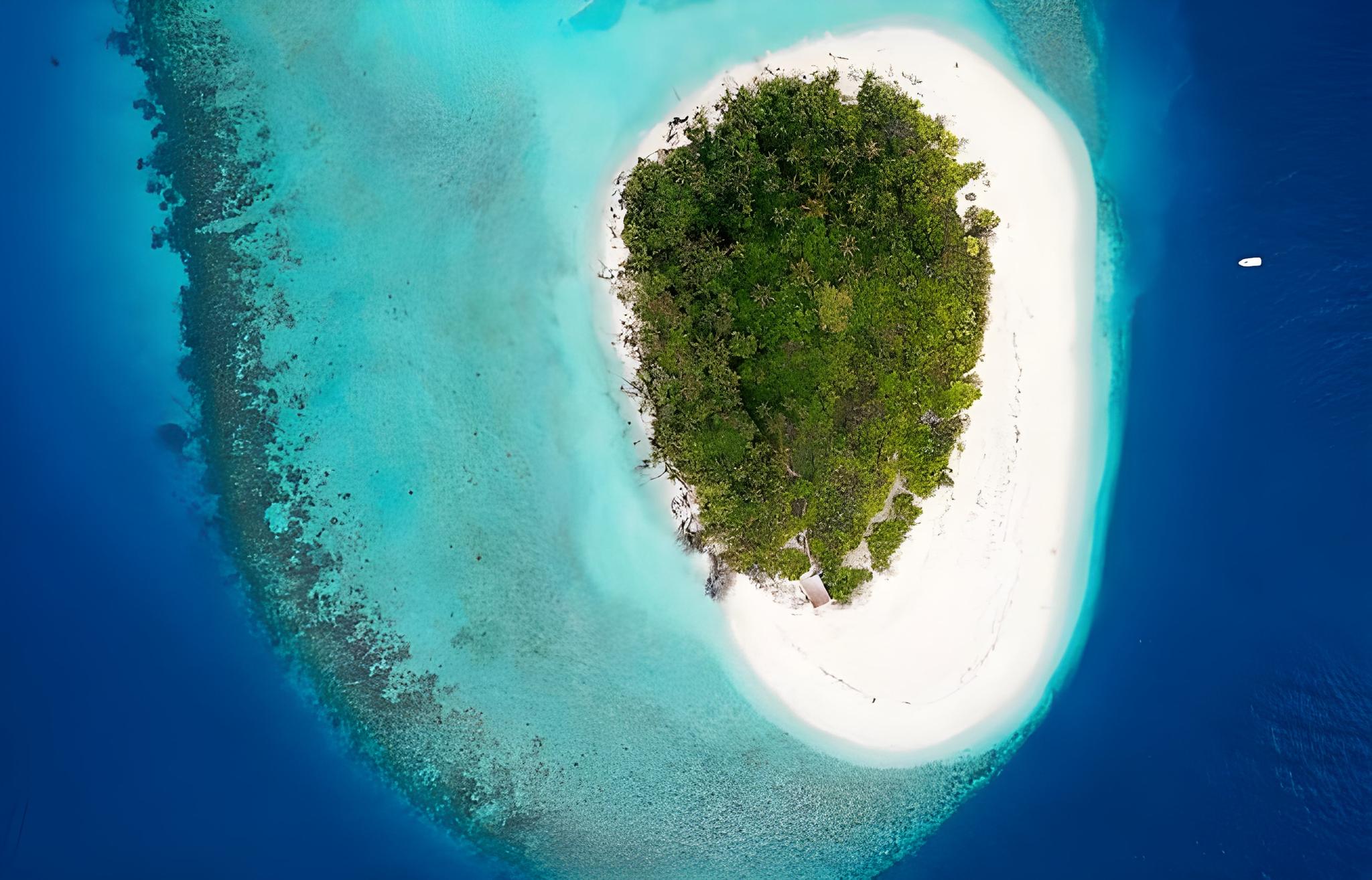 aerial view of small tropical island surrounded by turquoise waters