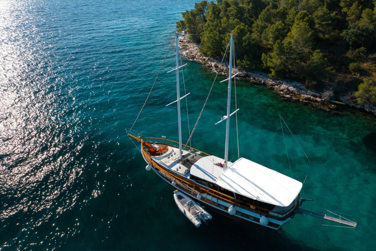 aerial view traditional wooden gulet yacht anchored crystal clear turquoise waters