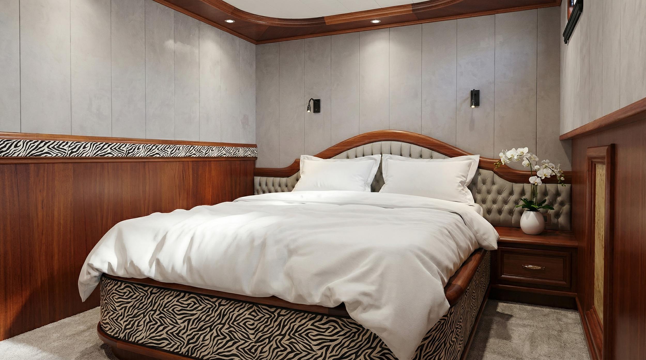 luxury yacht cabin featuring double bed with white linens and gray tufted headboard