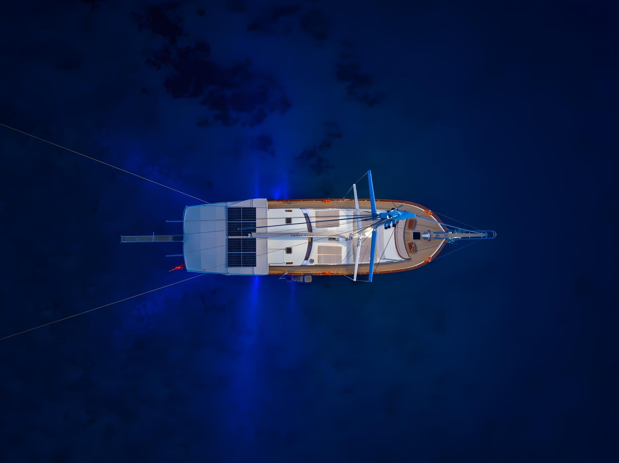 aerial drone shot of traditional gulet yacht anchored in deep blue Mediterranean waters