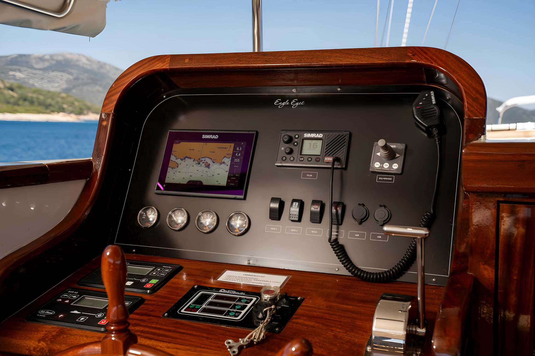 yacht helm station featuring SIMRAD chartplotter, engine controls, gauges and VHF radio