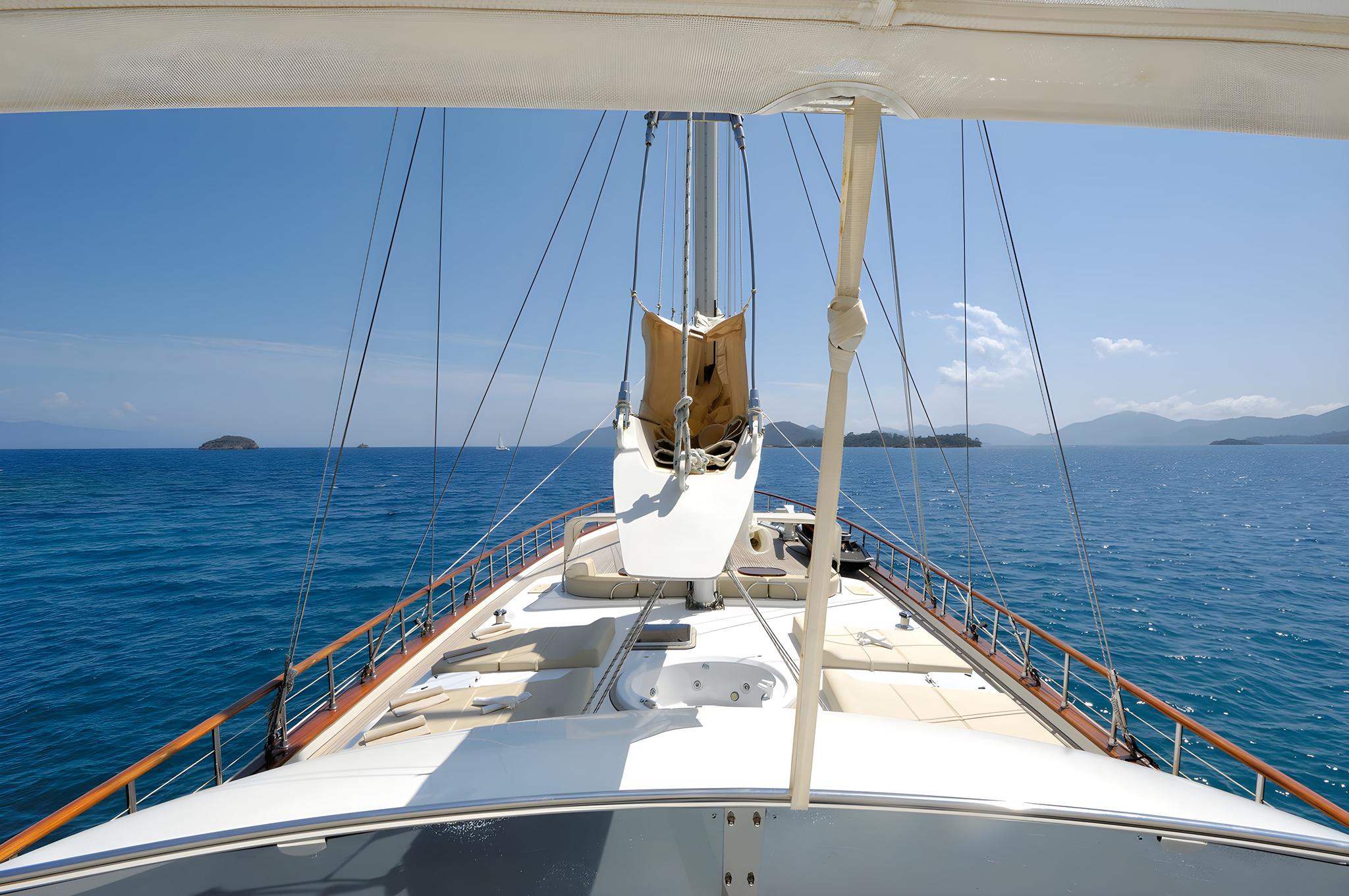 luxury gulet deck jacuzzi surrounded by white railings with traditional mast rigging