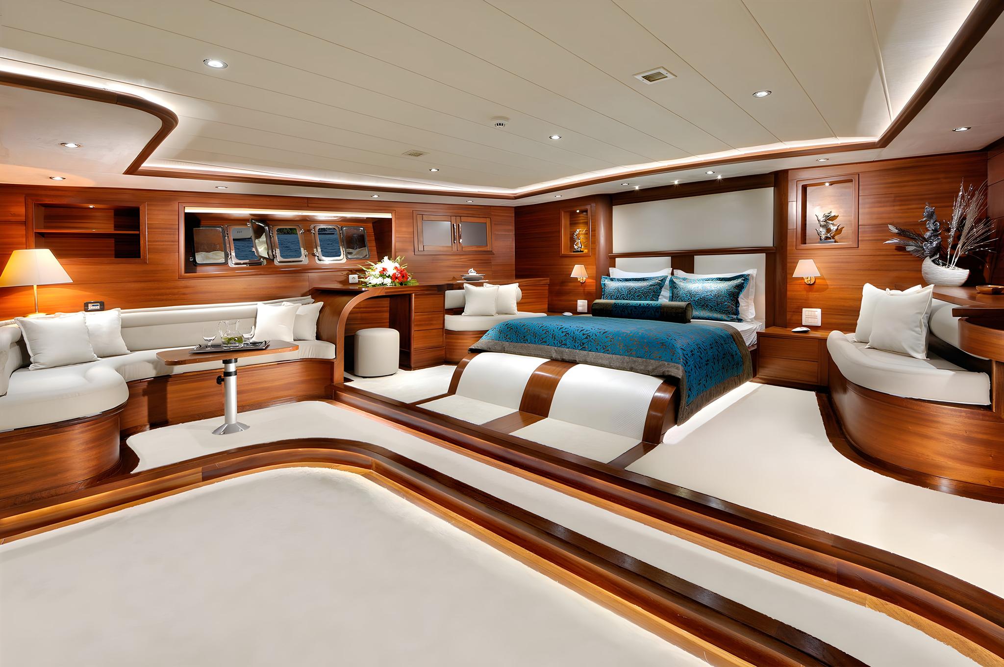 yacht master cabin featuring king bed with blue bedding, white seating area, and rich wood paneling