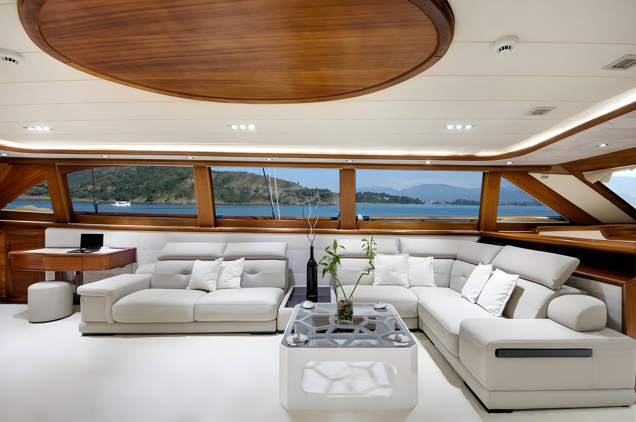 luxury yacht salon interior with white sectional sofas and panoramic windows