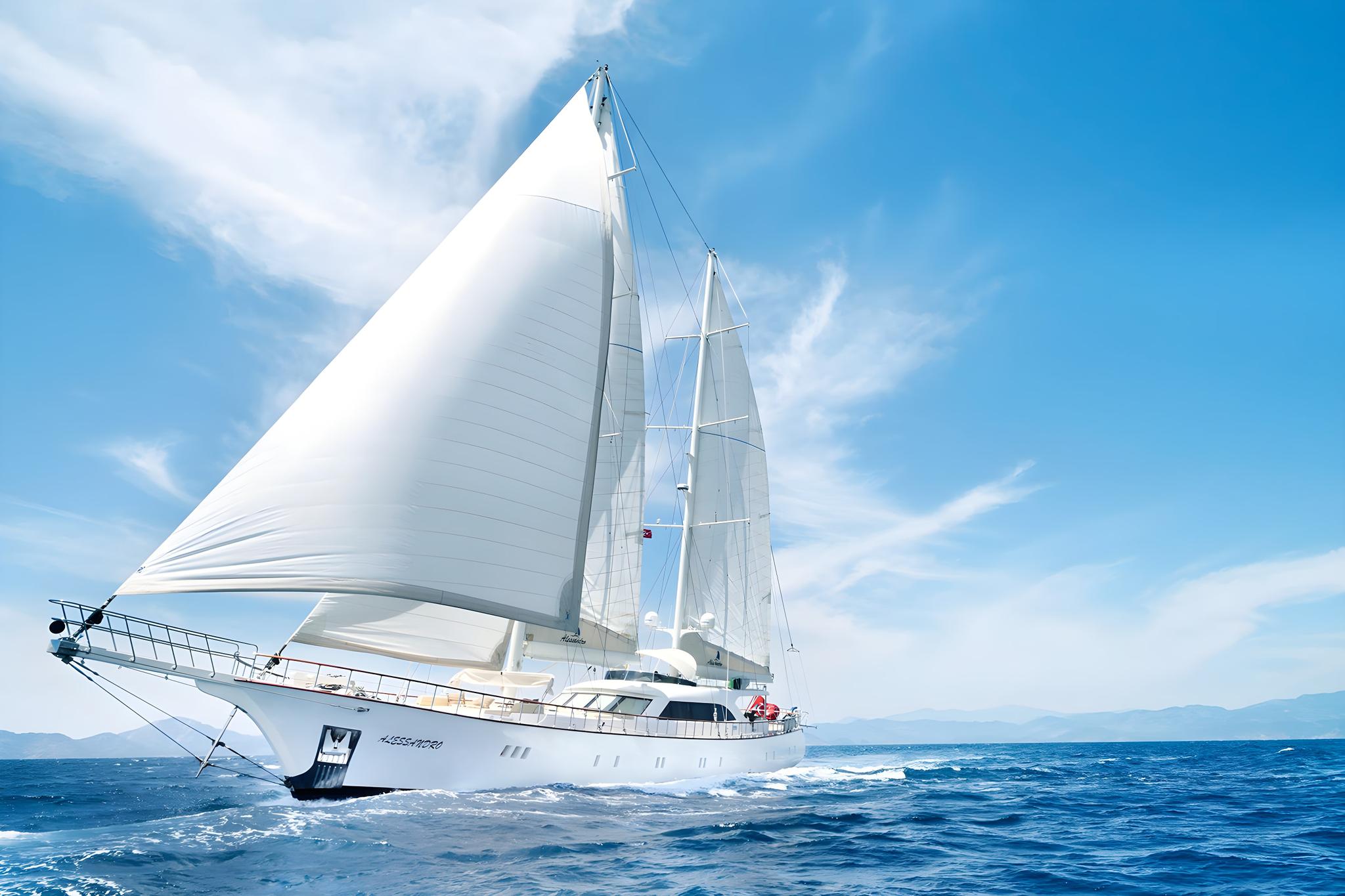 luxury sailing yacht with white hull and full sails deployed cruising on blue Mediterranean waters