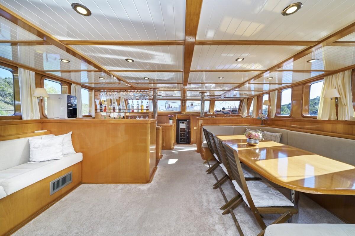 luxury yacht main salon featuring dining table and built-in seating