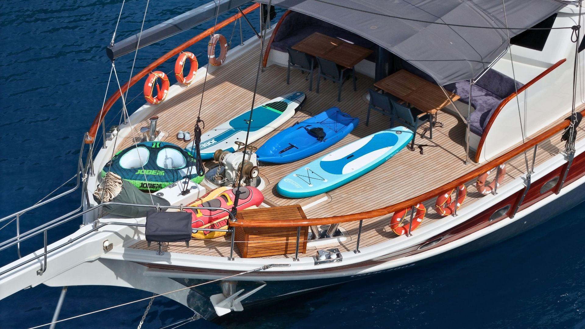 yacht deck with paddleboards, kayaks, seabob and inflatable water toys displayed
