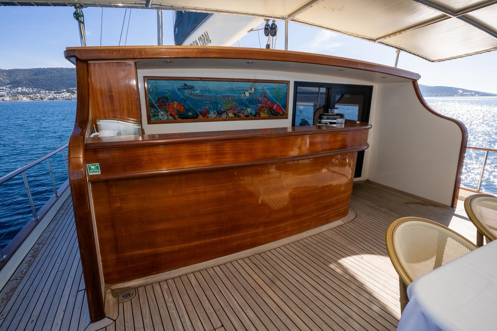 yacht aft deck curved bar unit with underwater marine life artwork and teak decking