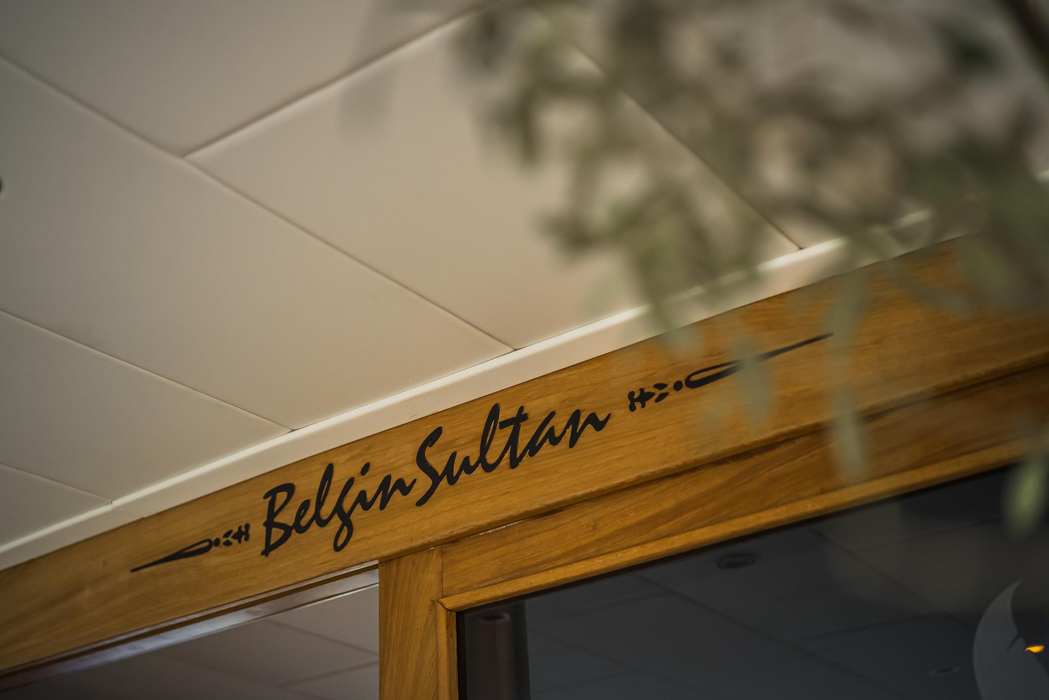 wooden doorframe with Belgin Sultan yacht name inscribed in black script lettering