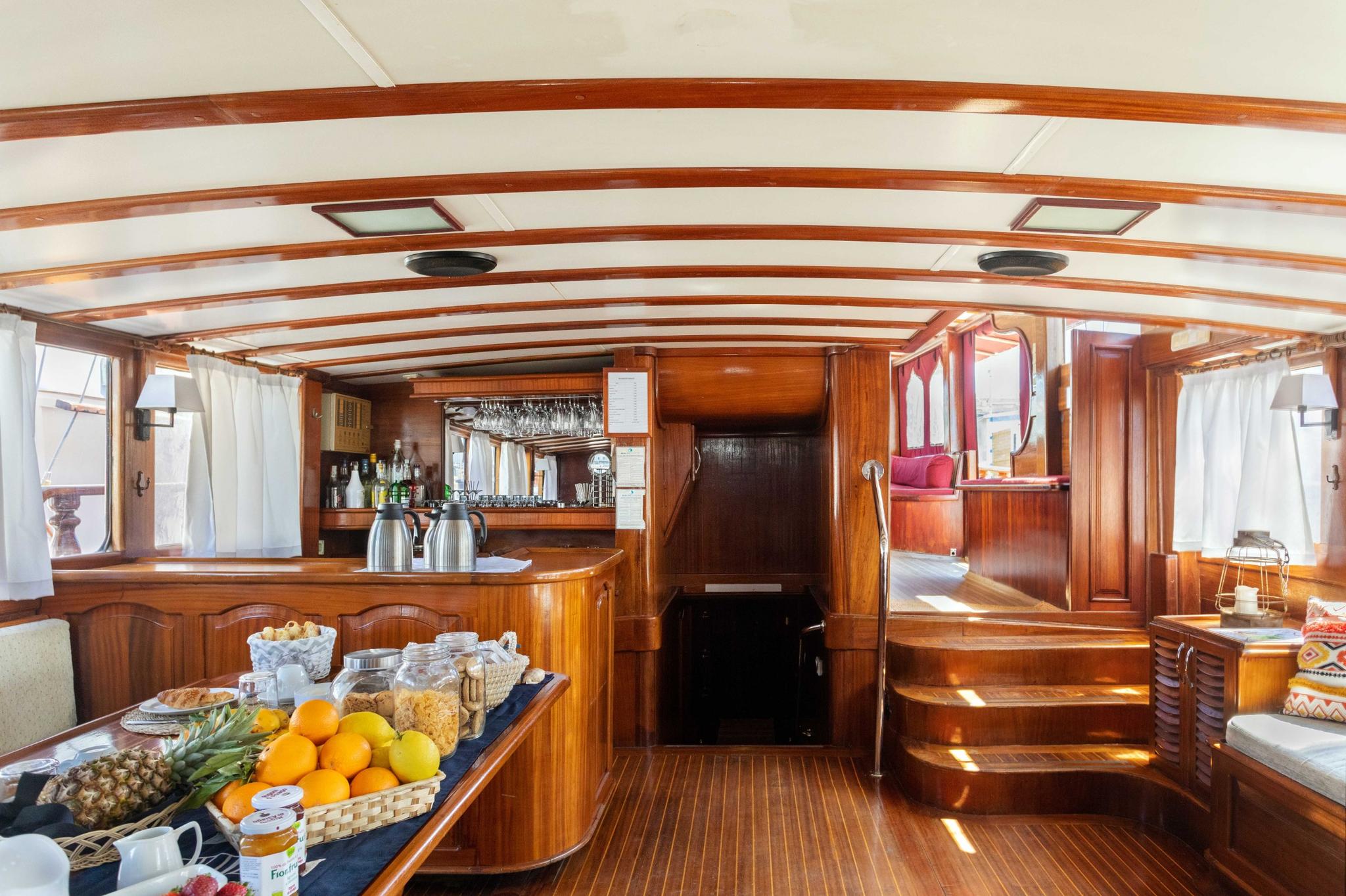 yacht galley with fresh fruit display, breakfast items, and beverage station setup