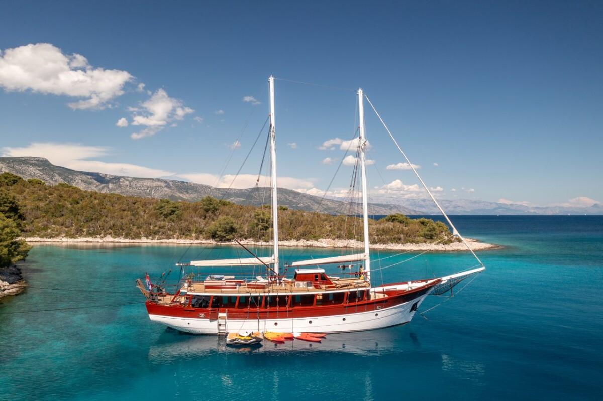 Classic wooden gulet yacht anchored in crystal clear Mediterranean waters