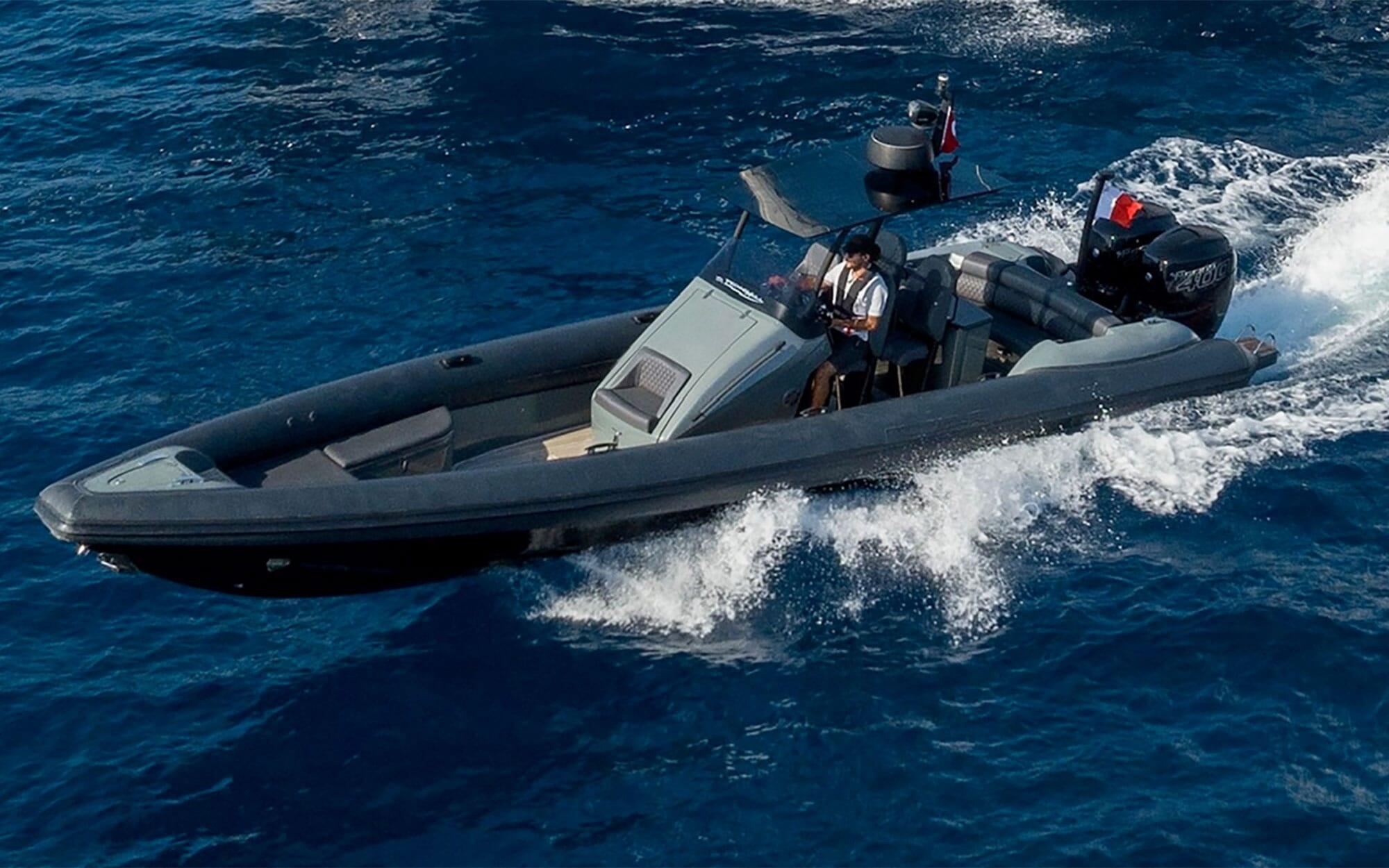 high-speed rigid inflatable boat tender with crew navigating through blue ocean waters