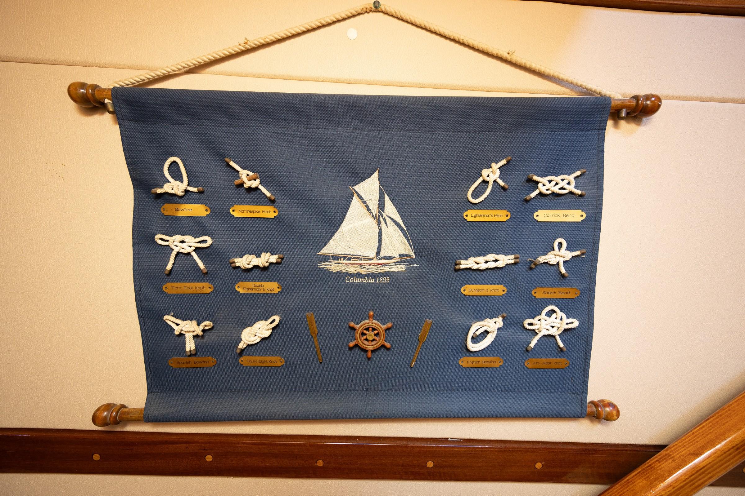 decorative wall-mounted nautical rope knot display board featuring 12 labelled knots and Columbia 1899 sailing vessel embroidery