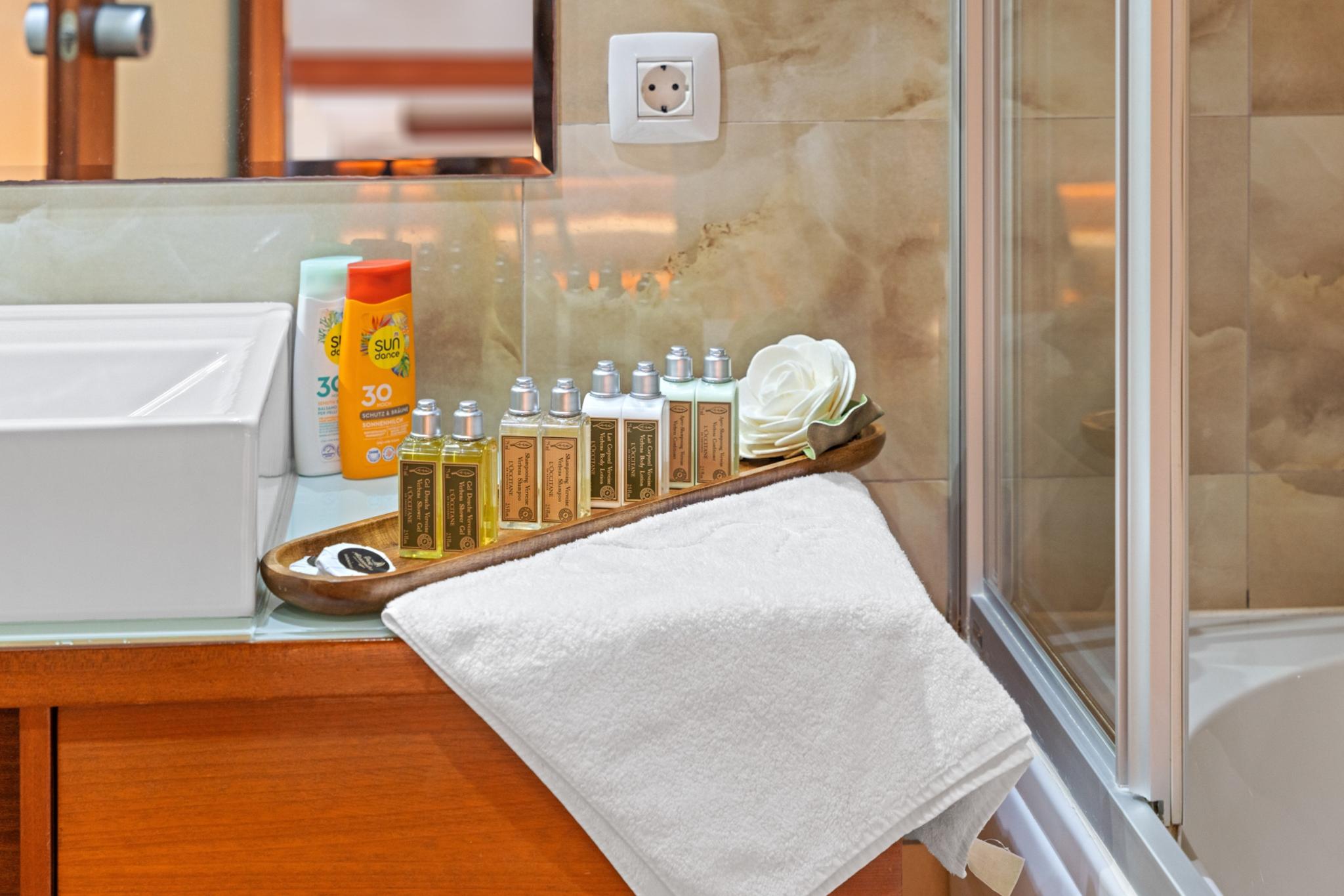 yacht bathroom vanity with premium toiletries, white towels and marble surfaces