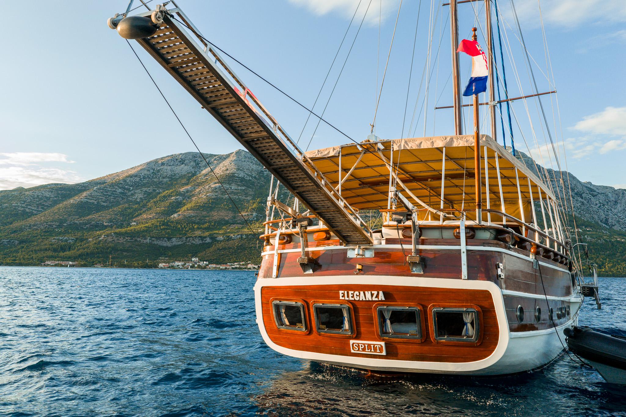 Wooden gulet Eleganza stern view showing cabin windows and Split port registry