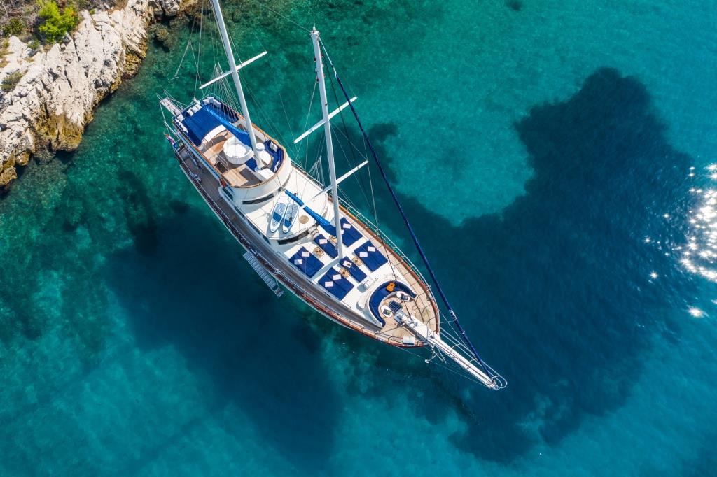 Aerial view luxury sailing gulet anchored crystal clear turquoise bay