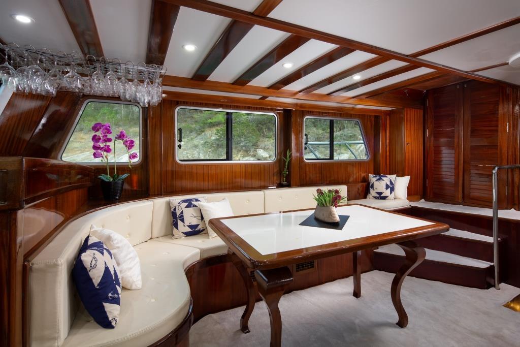elegant yacht salon interior featuring mahogany wood paneling and curved seating