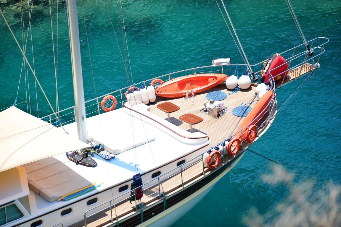 luxury gulet deck showing orange tender boat and water sports equipment