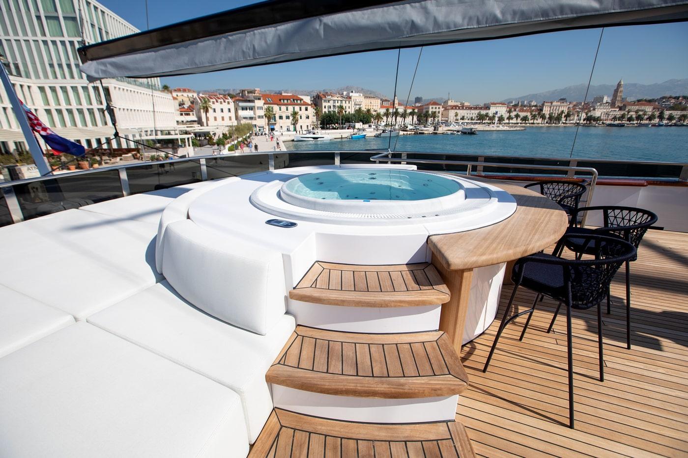 Luxury yacht jacuzzi hot tub with teak steps overlooking Mediterranean harbor