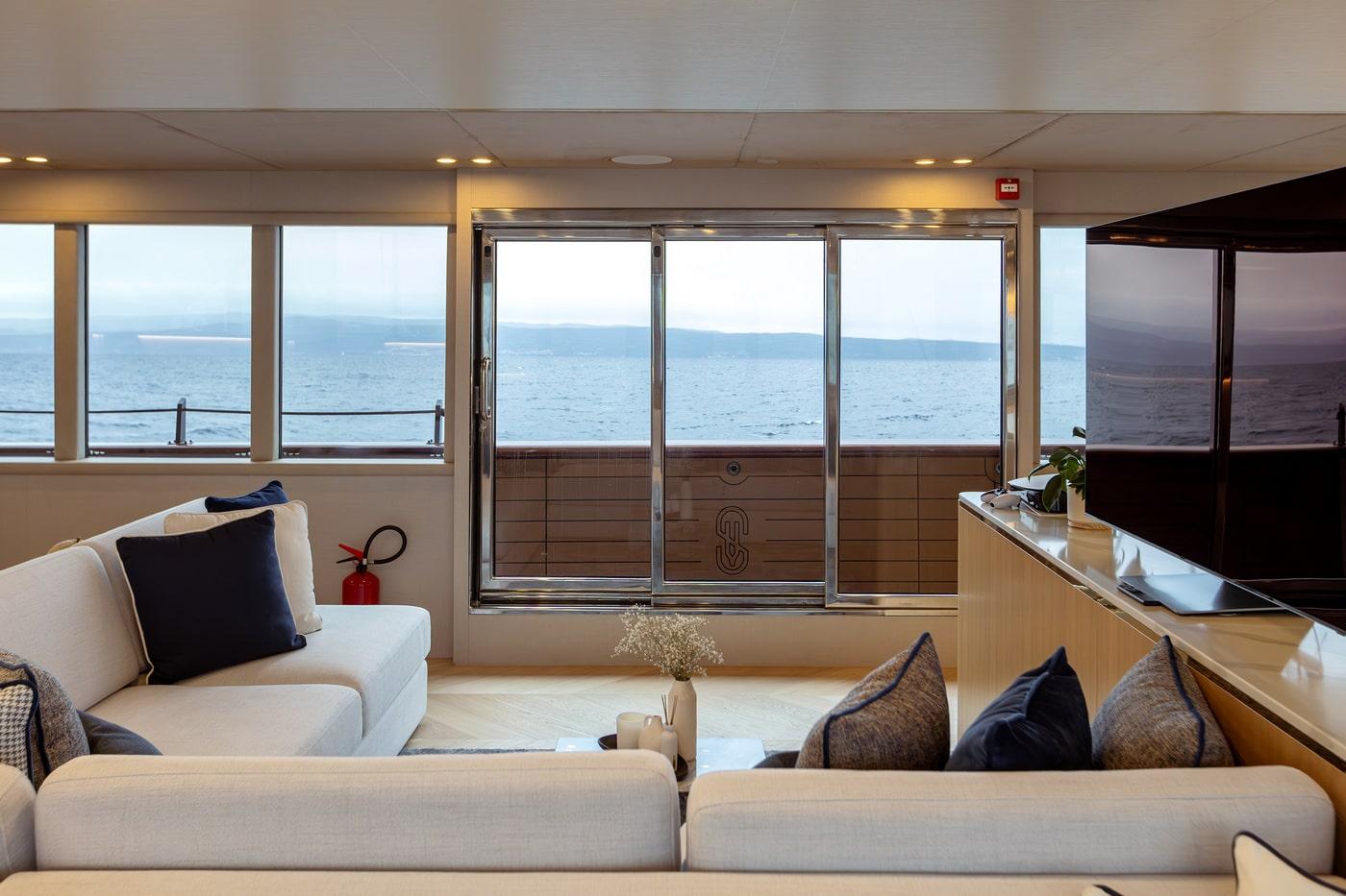 luxury yacht interior salon with cream sofas and panoramic windows