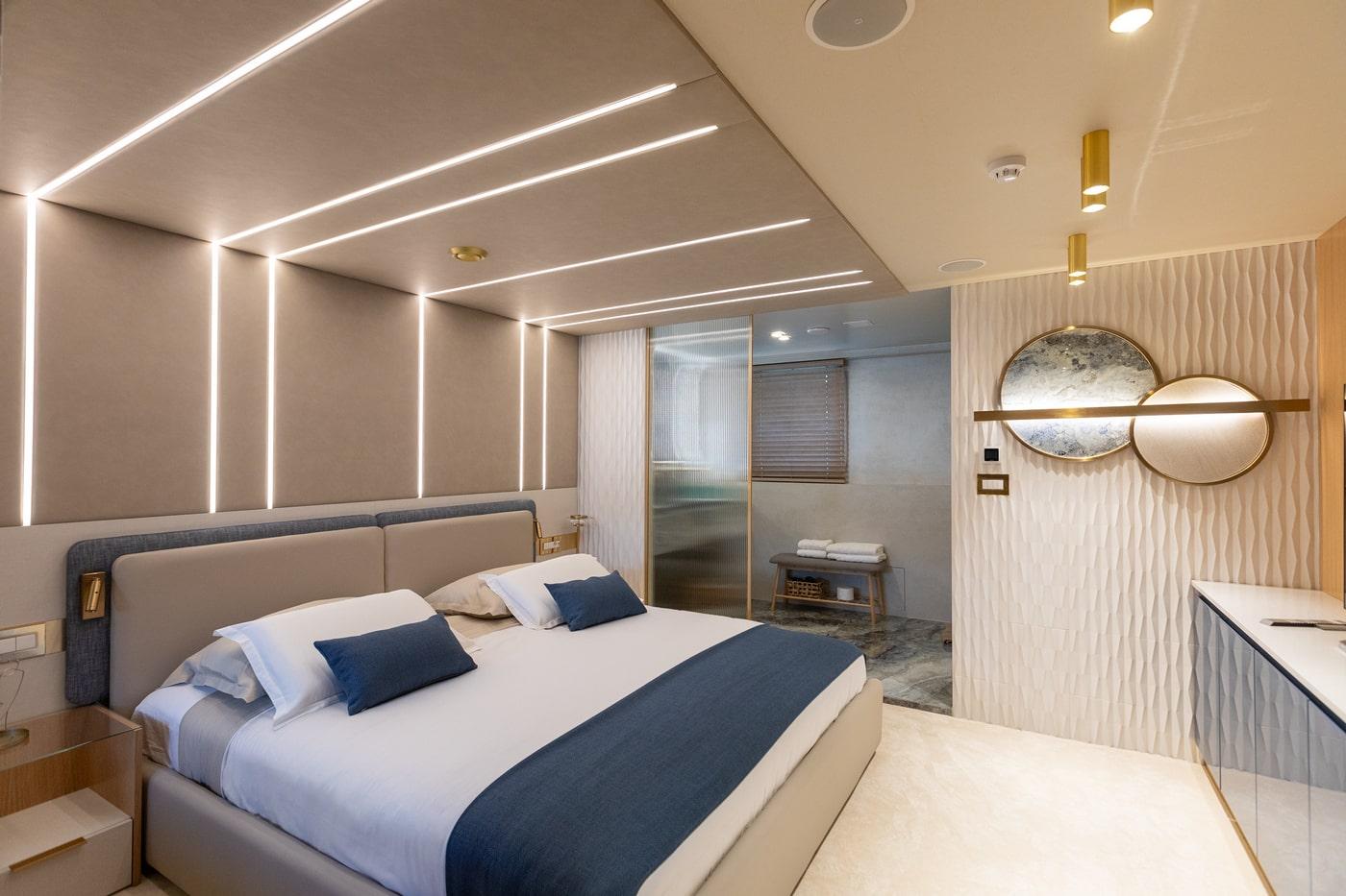 Modern yacht master cabin with navy blue accents and geometric LED lighting