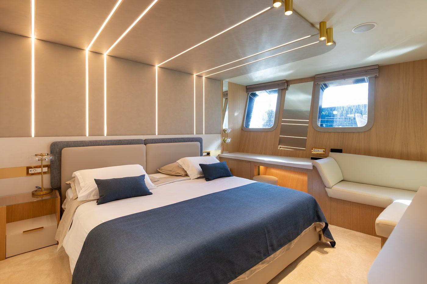 Luxury yacht master cabin with double bed navy accents wood paneling