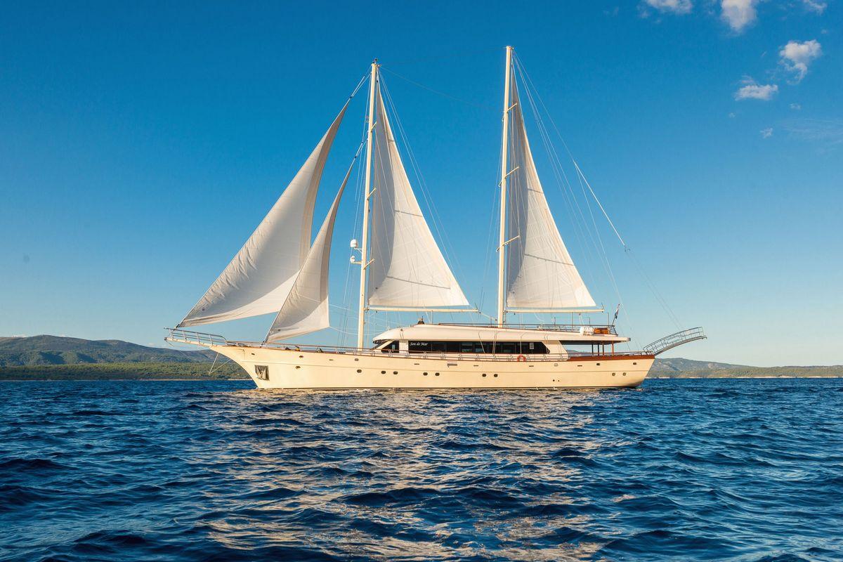 Luxury wooden gulet sailing yacht with white sails on Mediterranean waters