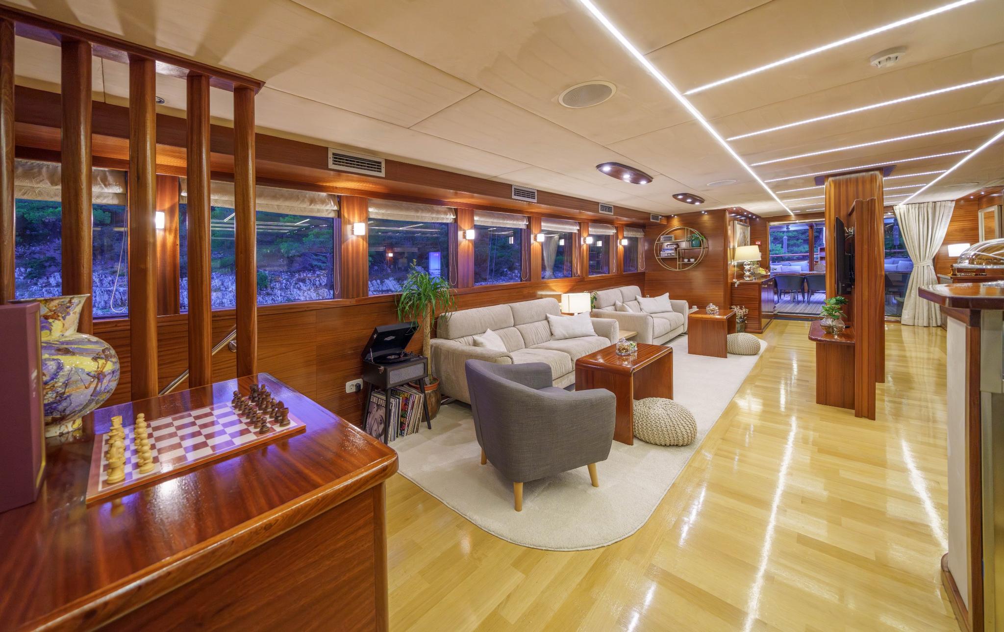 yacht games room featuring chess board, comfortable seating and entertainment storage