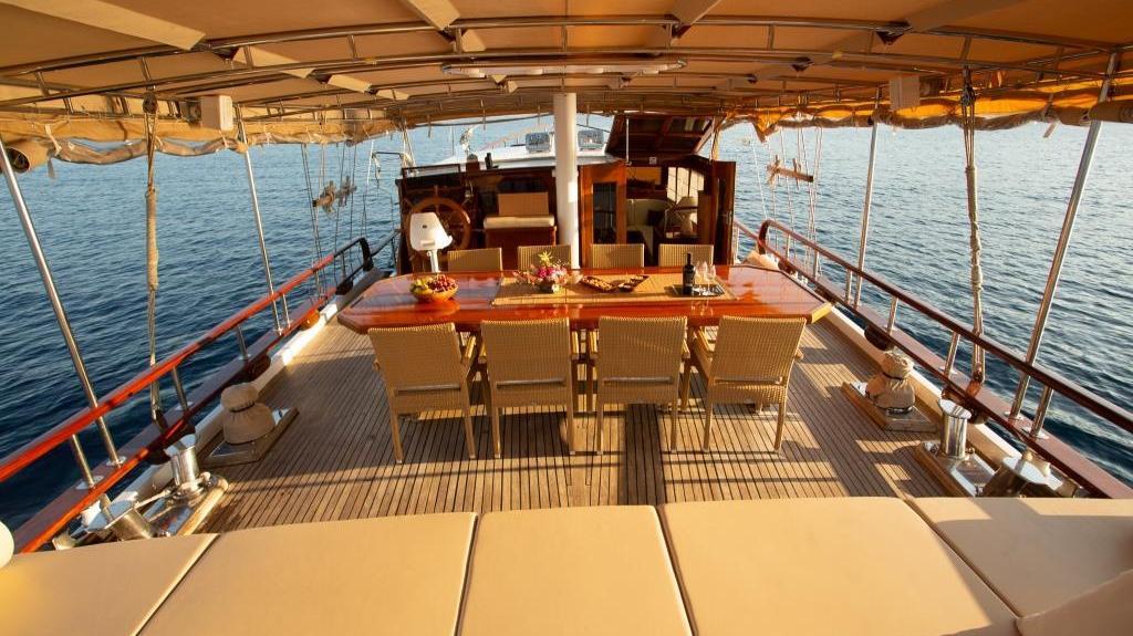 luxury gulet aft deck dining area with teak flooring and canvas canopy