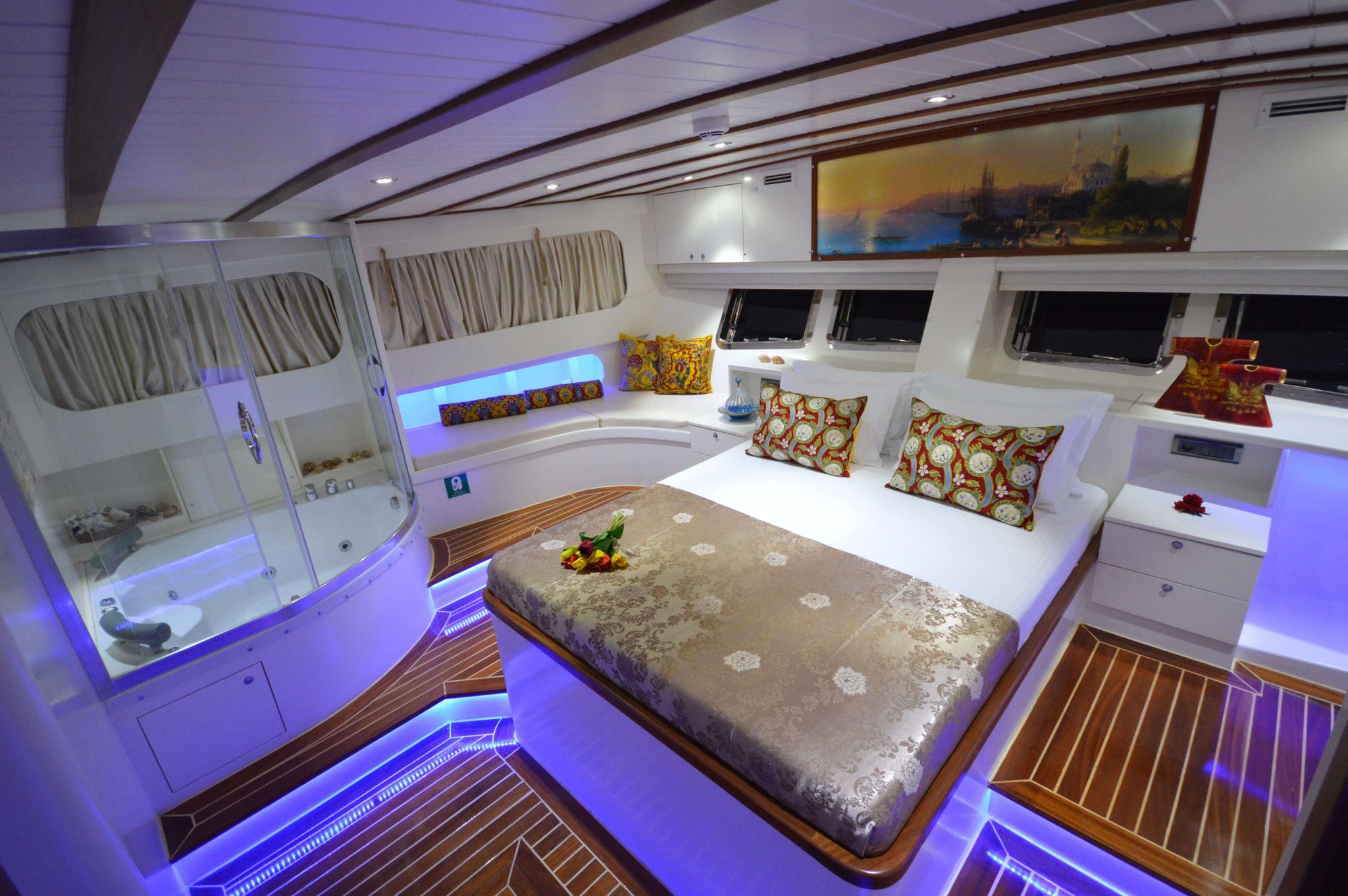 Master cabin with king bed, built-in jacuzzi, LED ambient lighting and teak flooring