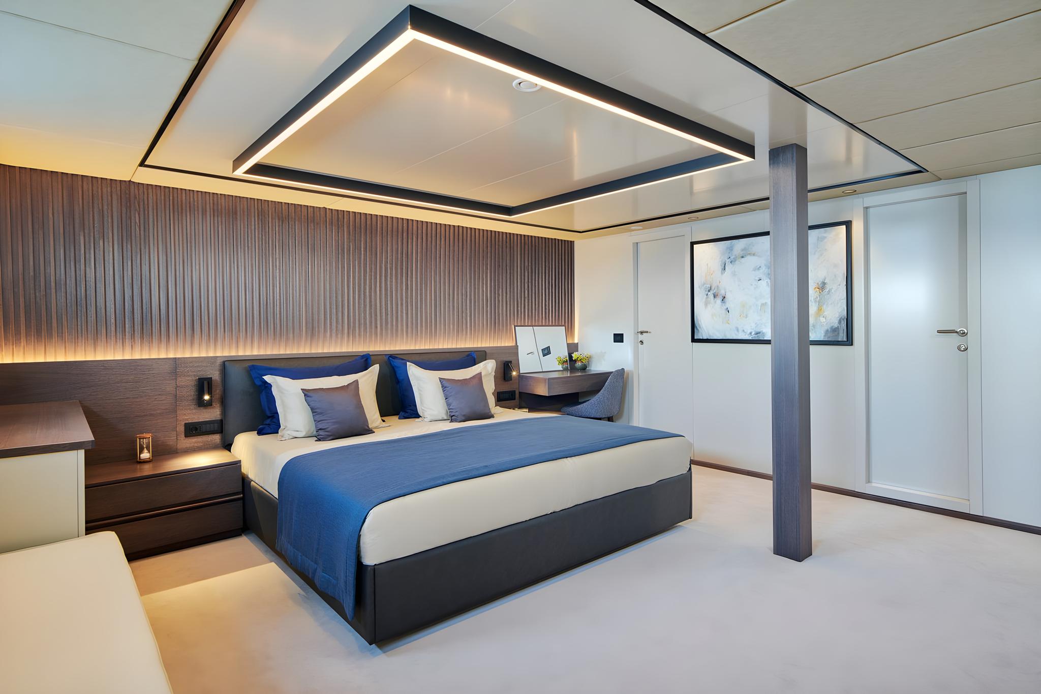 Luxury yacht master cabin interior with double bed and modern lighting
