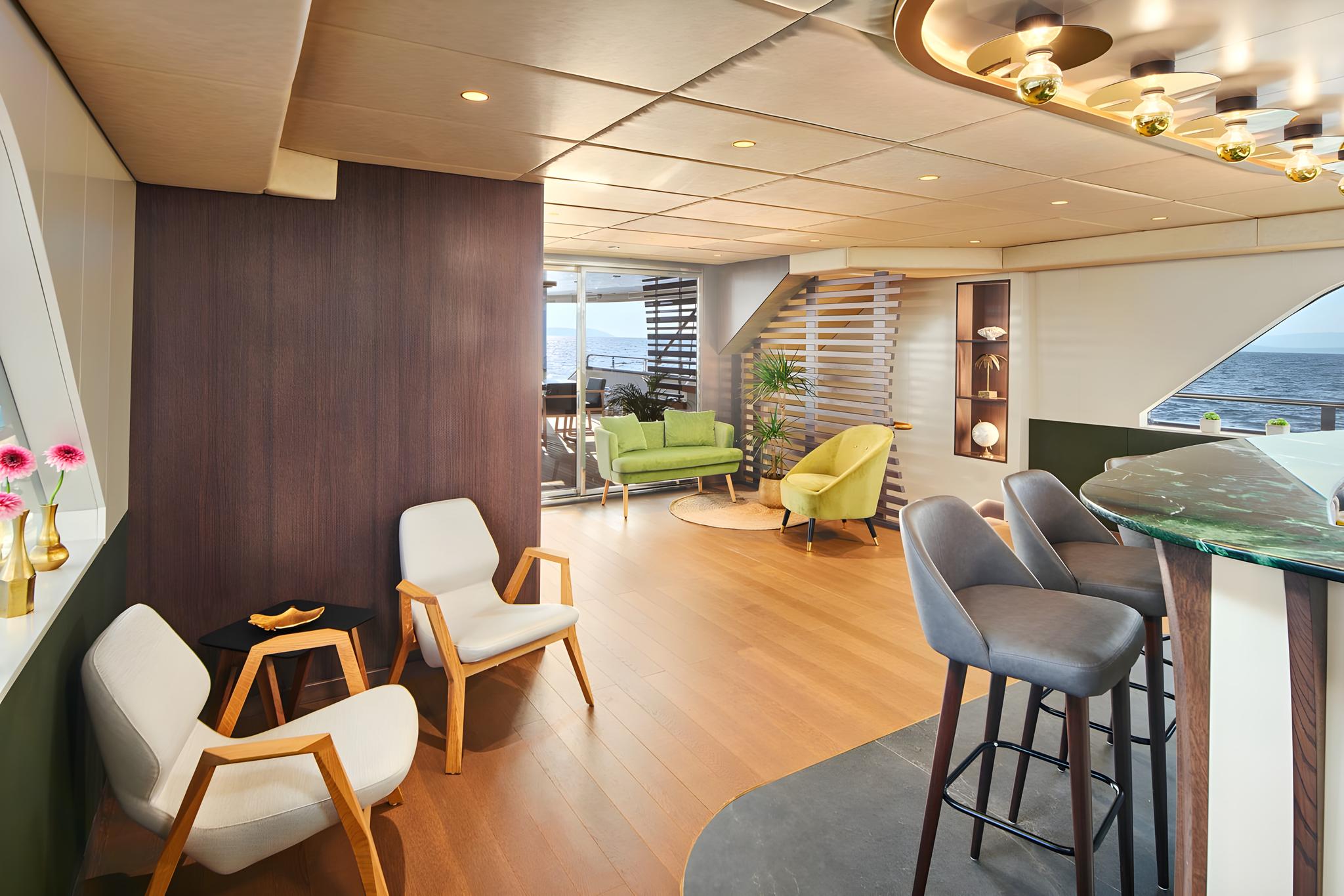 Luxury yacht salon interior with modern furniture, curved ceiling, and ocean views