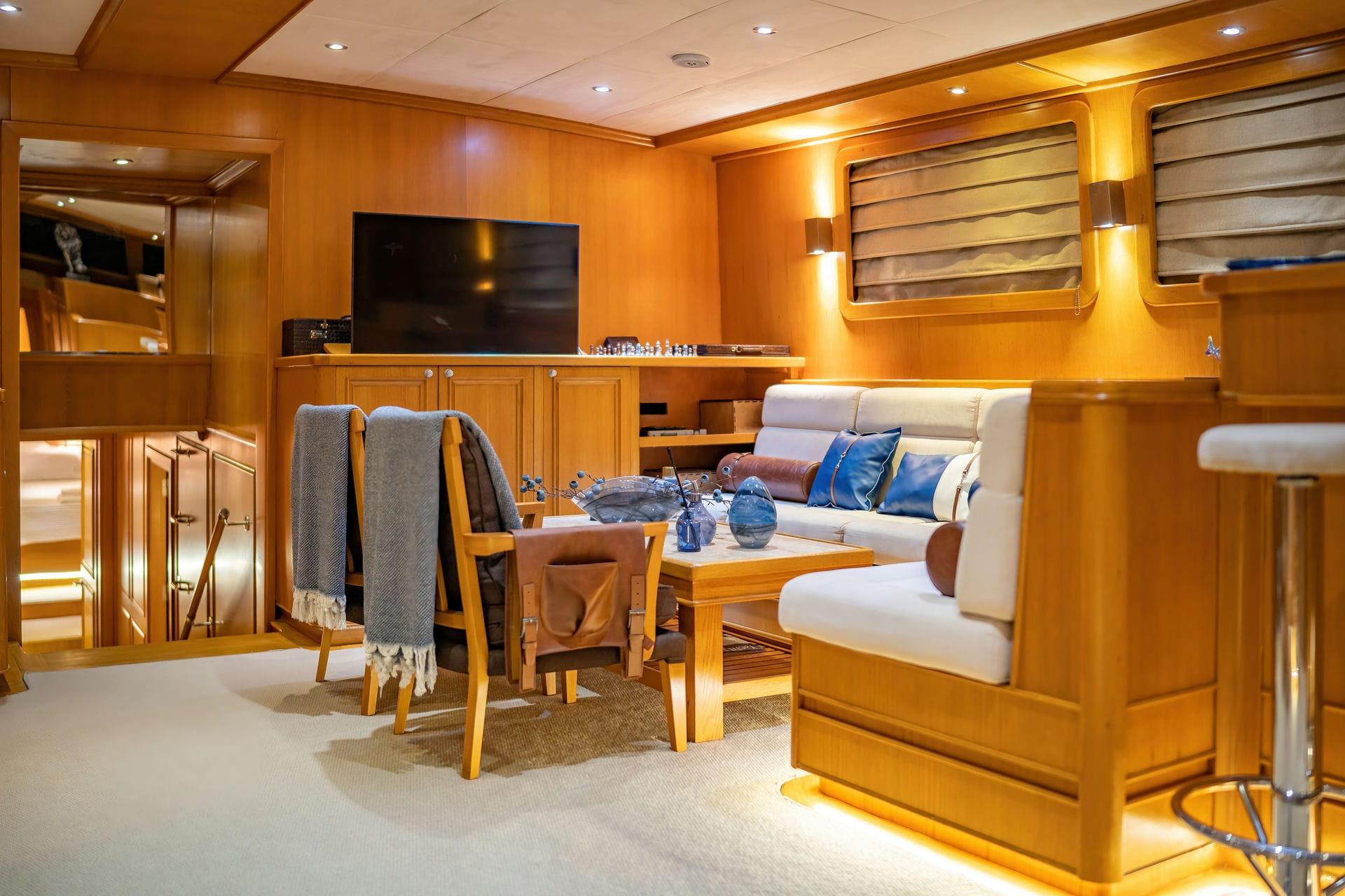 luxury yacht cinema room featuring large wall-mounted TV screen with comfortable seating area