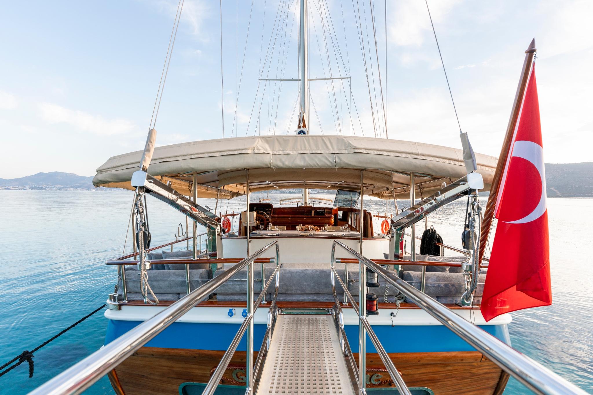 gulet aft deck with swimming platform, stainless steel railings and Turkish flag flying